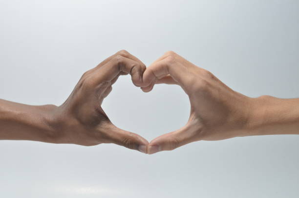 istock Hands of a couple forming a heart shape 1254440493