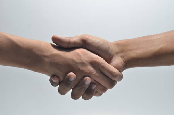 istock Hand Shake of two persons on isolated white background 1254440503