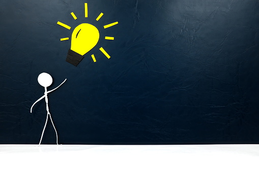 Human stick figure with yellow light bulb and copy space. New business idea and bright innovation concept.