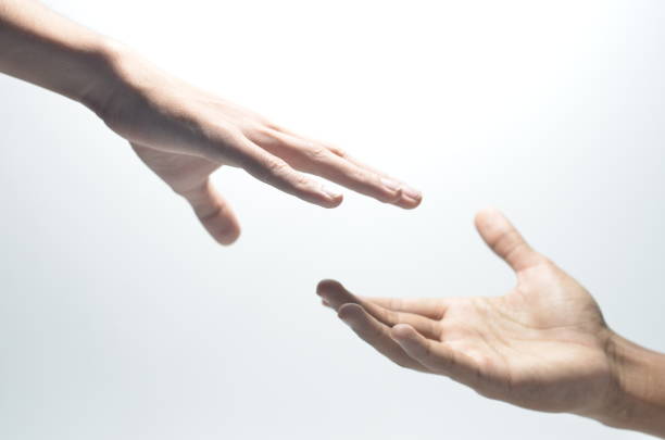 istock Two male hands reaching towards each other on isolated white background 1254440855