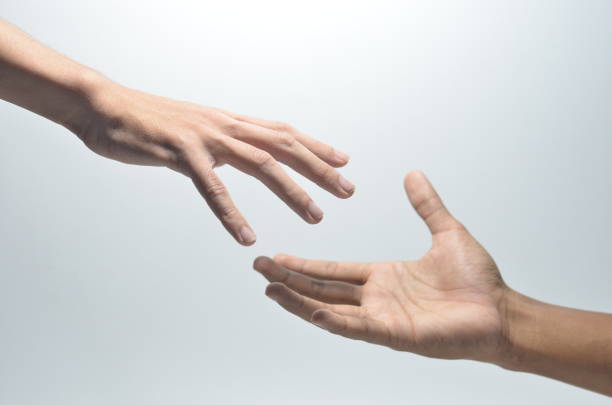 Two male hands reaching towards each other on isolated white background