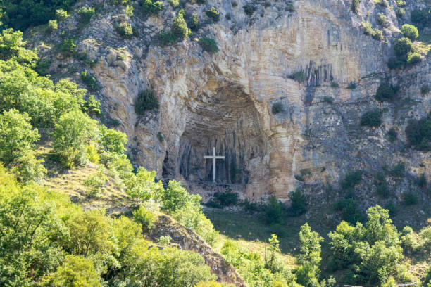 istock cross placed in a niche on a mountain 1254442015