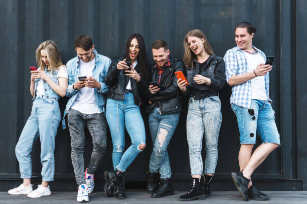 istock Group of young and stylish people using smartphones 1254442878