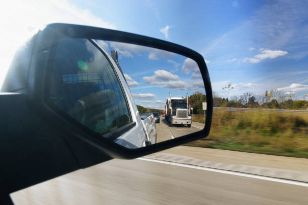 istock Semi-Truck in the Rear View Mirror 1254445575
