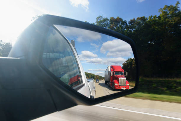 istock Semi-Truck in the Rear View Mirror 1254445604