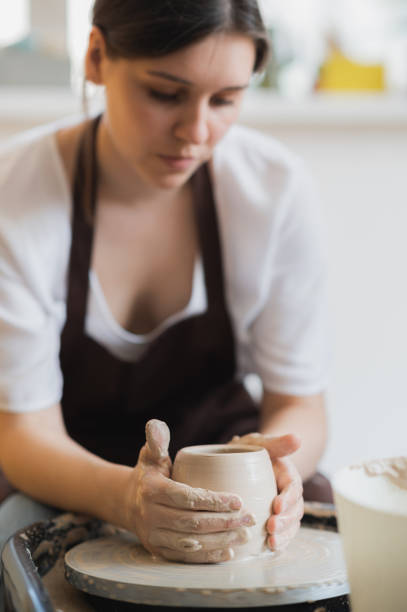 istock Master class on modeling of clay on a potter wheel In the pottery workshop 1254446722