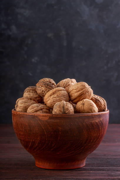 istock Walnut oret in a clay bowl with a place under the text 1254447004