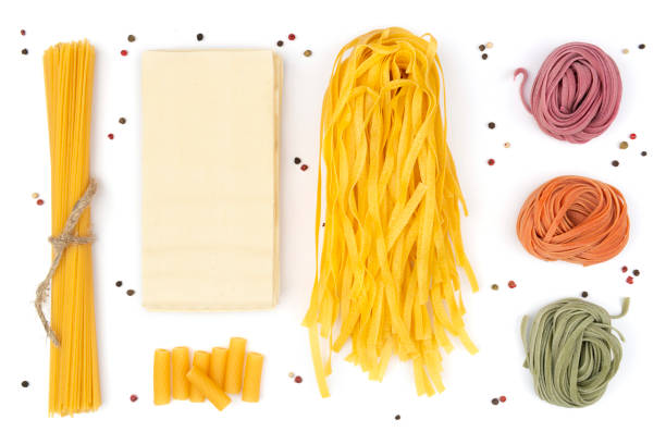istock Ordered set of different kind of pasta and peppers on white background 1254451686