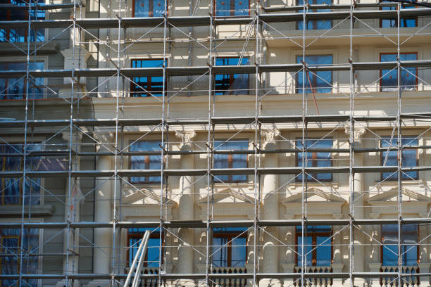 istock modern building under construction, plastered walls and scaffolding, construction crane 1254454387