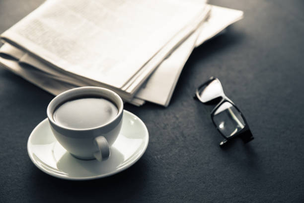 istock glasses on newspapers with coffee 1254454426