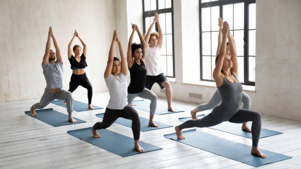 istock Motivated happy multiracial people doing surya namaskar. 1254455277