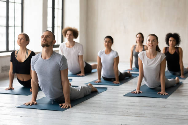 istock Young multiethnic people in activewear doing Bhujangasana Cobra pose. 1254455283