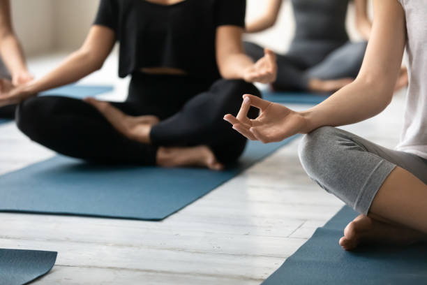 istock Close up young woman folded fingers in mudra gesture. 1254455312