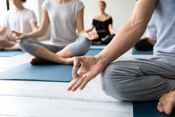istock Close up mudra gesture folded hand on knee. 1254455317