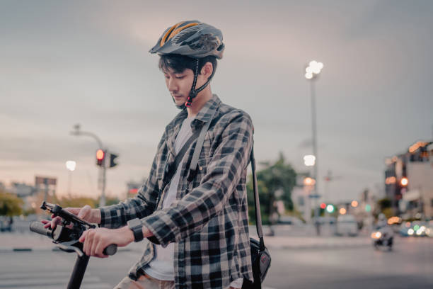 istock young asian man tourists rides an e-scooter 1254456531