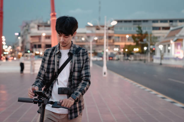 istock young asian man tourists rides an e-scooter 1254456569