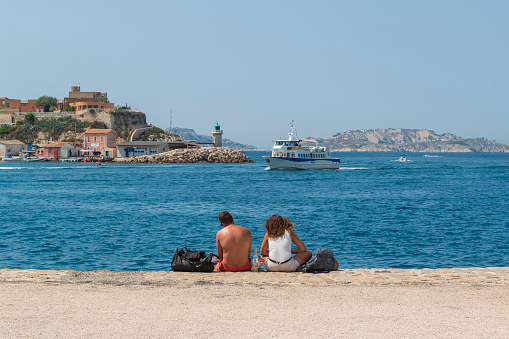 2018-08-22 Marseille, France. Tourists at the seafront of Marseille in hot summer day. Marseille promenade. Famous tourist attraction in France.