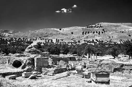 Stone ruins of the ancient Roman city of Gortyn on the island of Crete in Greece, black and white