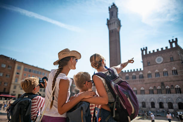 семейный осмотр достопримечательностей сиена, италия - torre del mangia стоковые фото и изображения