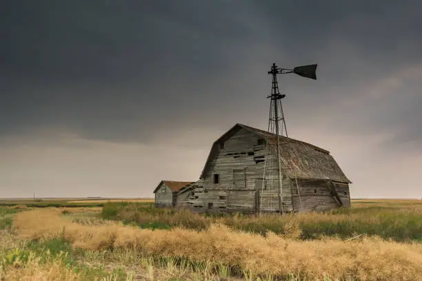 Photo of Moody sky over an abandoned prairie barn