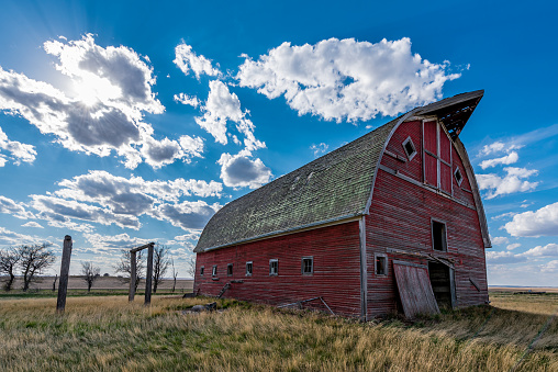 An abandoned red barn on the prairies in Saskatchewan, Canada