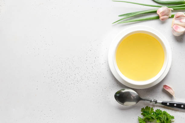 istock Chicken broth with parsley in bowl on white table. Copy space. Top view. 1254465848