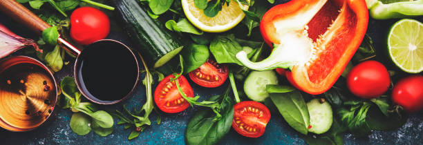 fresh heathy food cooking or salad making ingredients on dark background with rustic wooden board. diet or vegetarian food concept. panoramic banner with copy space - heathy food imagens e fotografias de stock