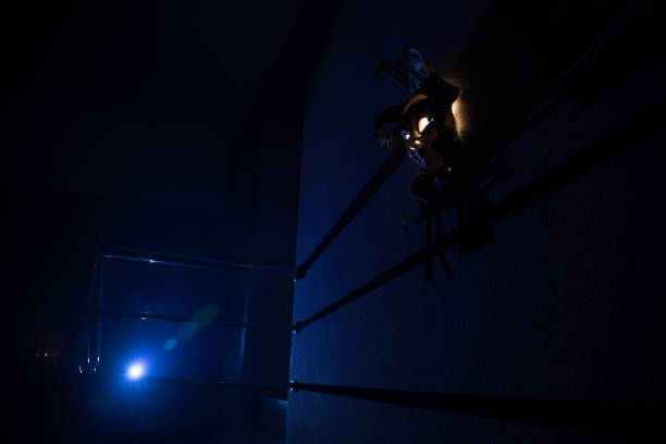 istock Horror concept. Scary mask with light on the wall inside dark room. Selective focus 1254467547