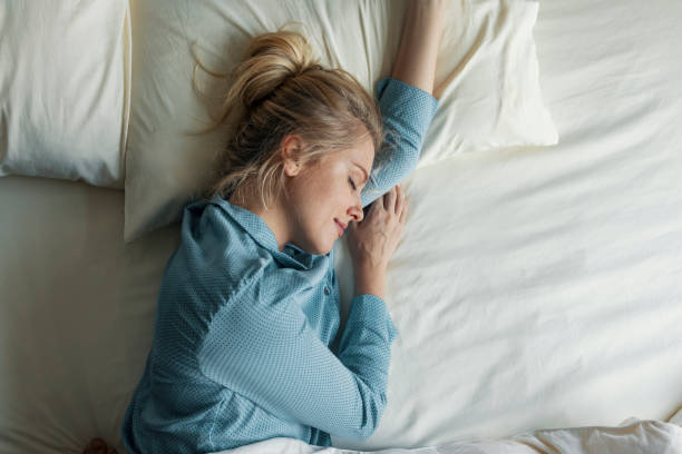 istock Beautiful Blonde Woman Sleeping Peacefully in her Bed 1254467737