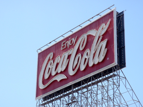 San Francisco - June 29, 2009: Enjoy Coca-Cola Neon Sign during the day against a blue sky.  The display, located at 701 Bryant St. (Bryant and 5th St.) and near San Francisco's famed flower market. Historic sign was up for 75 years before updating.
