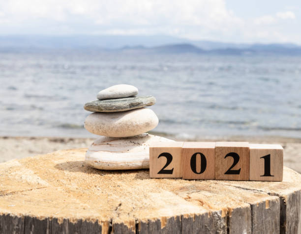 istock 2021 text on wooden cubes on tree stump. Close up. 1254471151