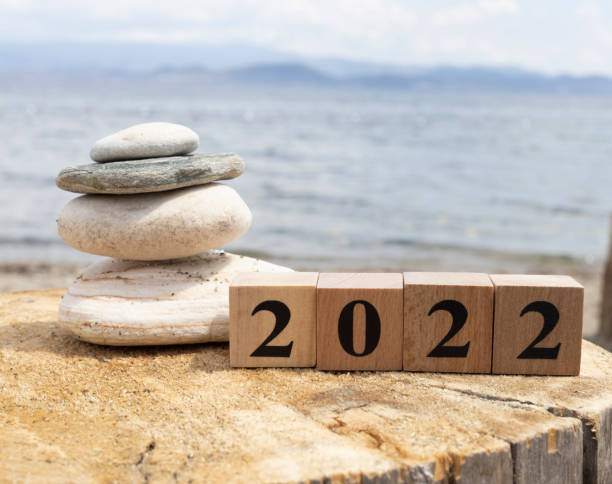 istock 2022 text on wooden cubes on tree stump. Close up. 1254473352