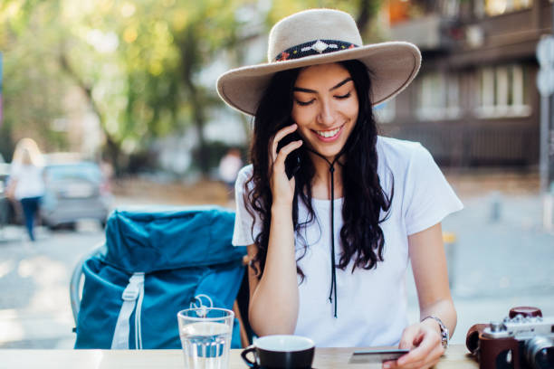 istock Beautiful tourist taking a break and ordering something 1254473527