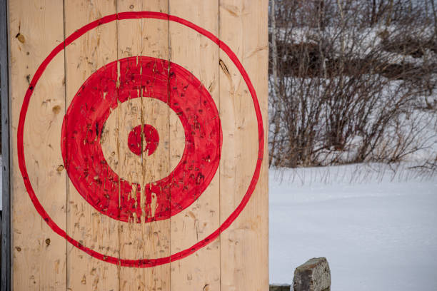 axe target An axe throwing target has been set up and used on this snowy day axe throwing stock pictures, royalty-free photos & images