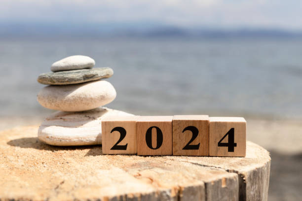 istock 2024 text on wooden cubes on tree stump. Close up. 1254474093