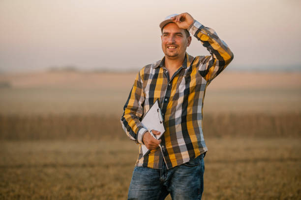istock Farmer or agronomist with a clipboard, inspecting  fields 1254474330