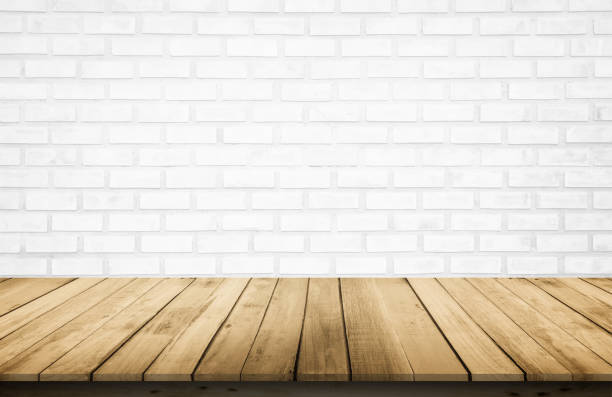 istock Empty wooden table top on white brick wall background, Design wood terrace white. Perspective for show space for your copy and branding. Can be used as product display montage. Vintage style concept. 1254476704