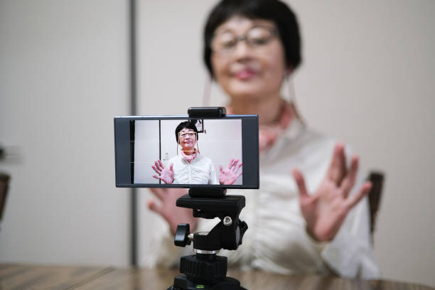 istock Asian senior youtuber talking to smart phone 1254479628