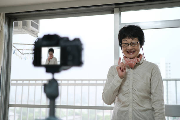 istock Senior youtuber broadcasting from home 1254479642