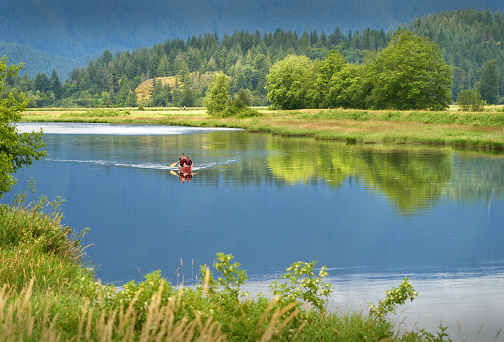 A view of canoe by the beautiful lake with summer Forres surrounding in Nordland, Northern Norway, Scandinavia