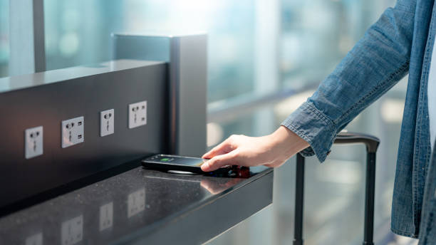 istock Male hand putting smartphone on wireless charger 1254489102