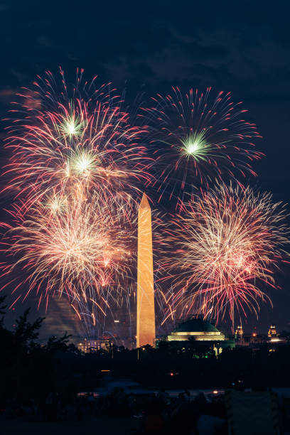 George Washington monument at night with fireworks George Washington monument in Washington DC at night with fireworks. washington monument washington dc stock pictures, royalty-free photos & images