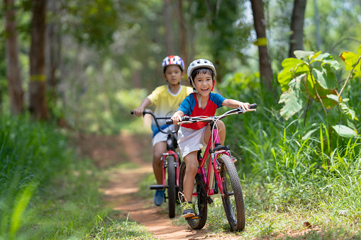 Asian children are happy mountain biking.