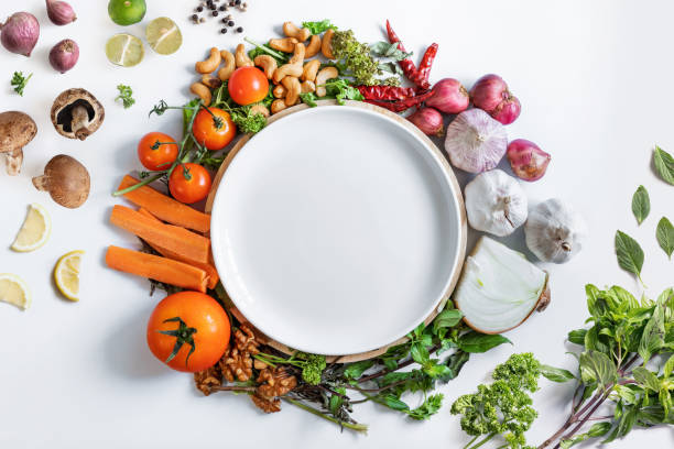 istock White ceramic dish surrounding with fresh healthy vegetables, on white background 1254494817
