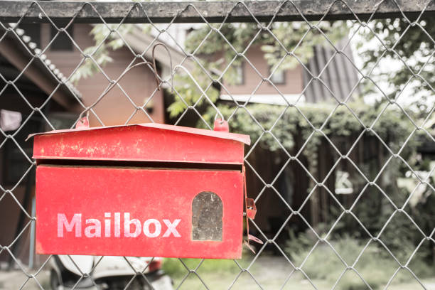 istock Red mailbox On the fence. 1254498192