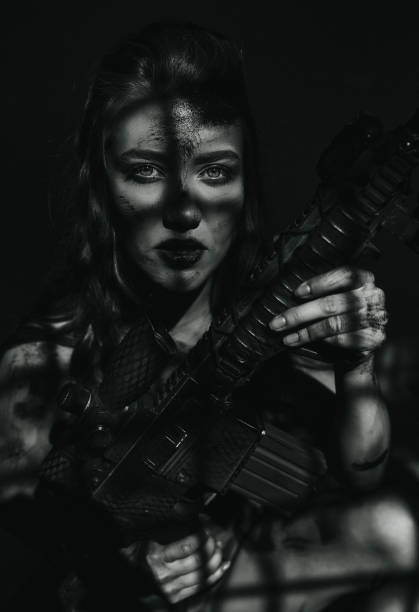 Feeling courageous and revengeful Angry female warrior holding large rifle, feeling courageous and looking at the camera with serious face female sharp shooter stock pictures, royalty-free photos & images