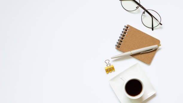 istock Notebook, pen, cup of coffee, glasses, clip on white background. Work and study place. flat lay, top view, copy space 1254500440