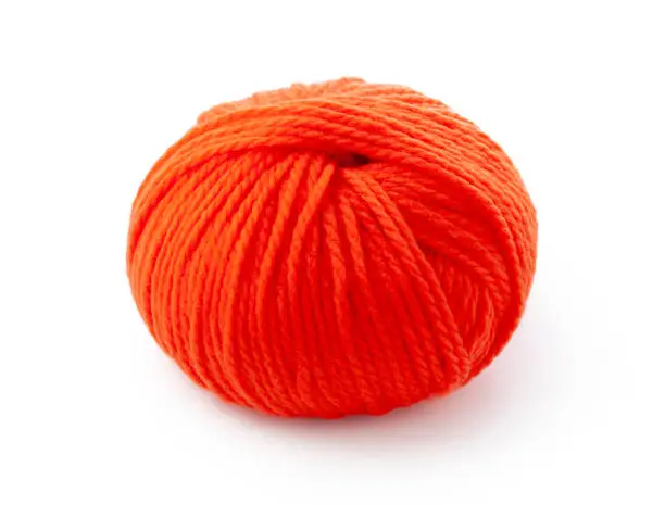 Orange ball of wool isolated on white background.