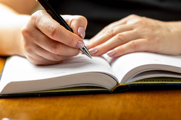 istock Female hand over notepad closeup. 1254503571
