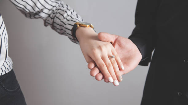 istock Man and woman hands with engagement ring. 1254504374